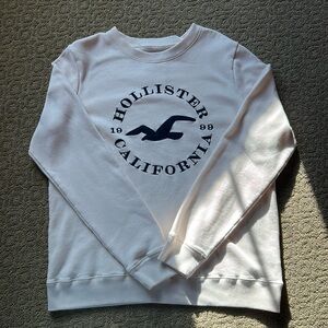 Hollister size Large cream-colored crewneck hoodie, navy blue embroidery.